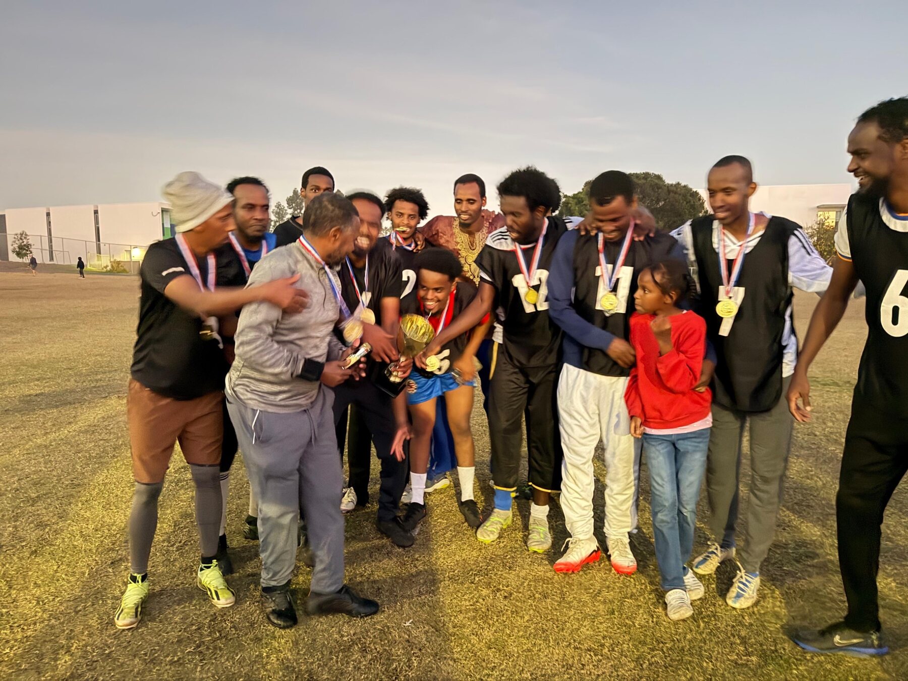 Players and community members celebrating with medals