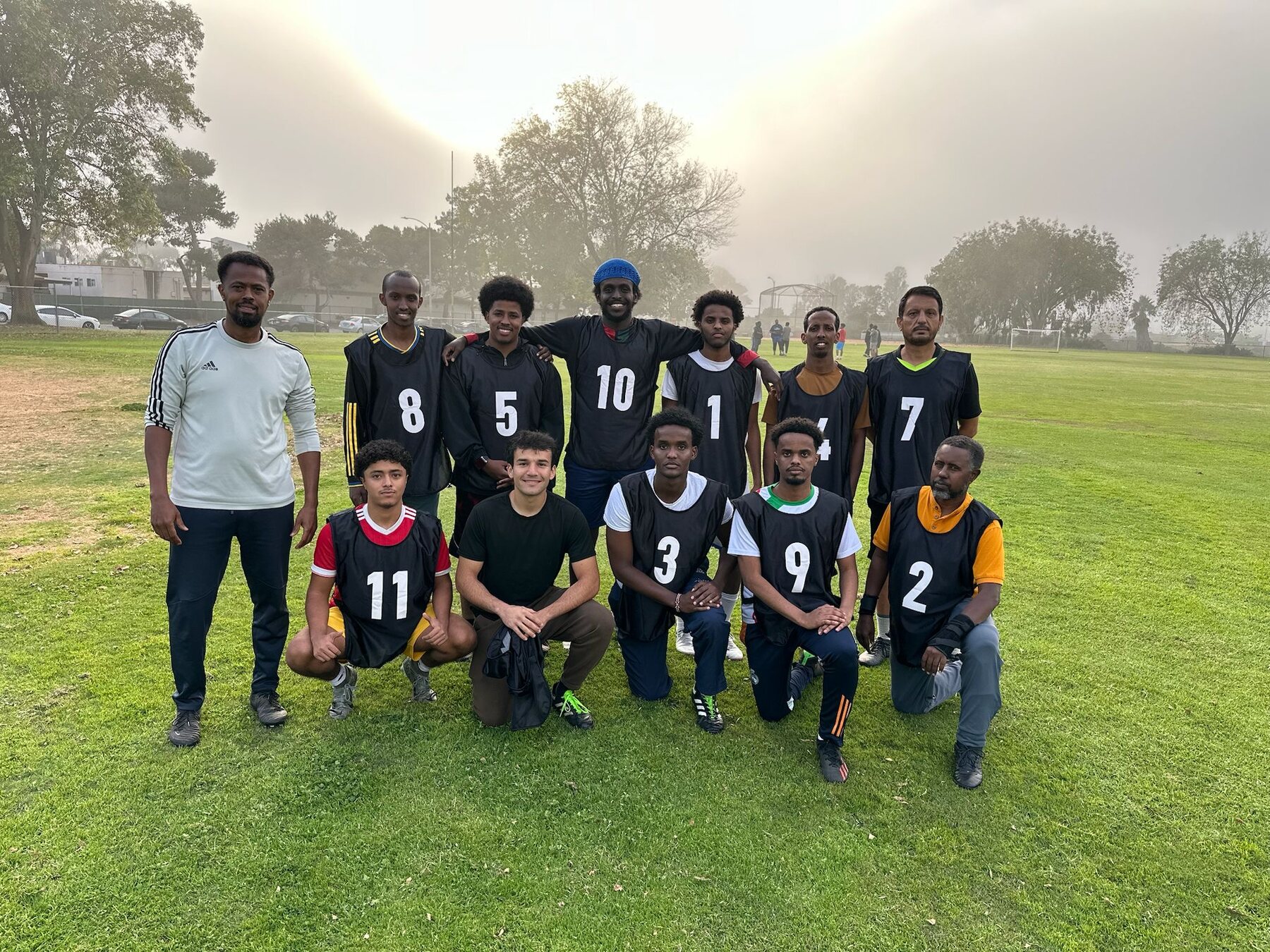 Black team gathered on a community soccer field
