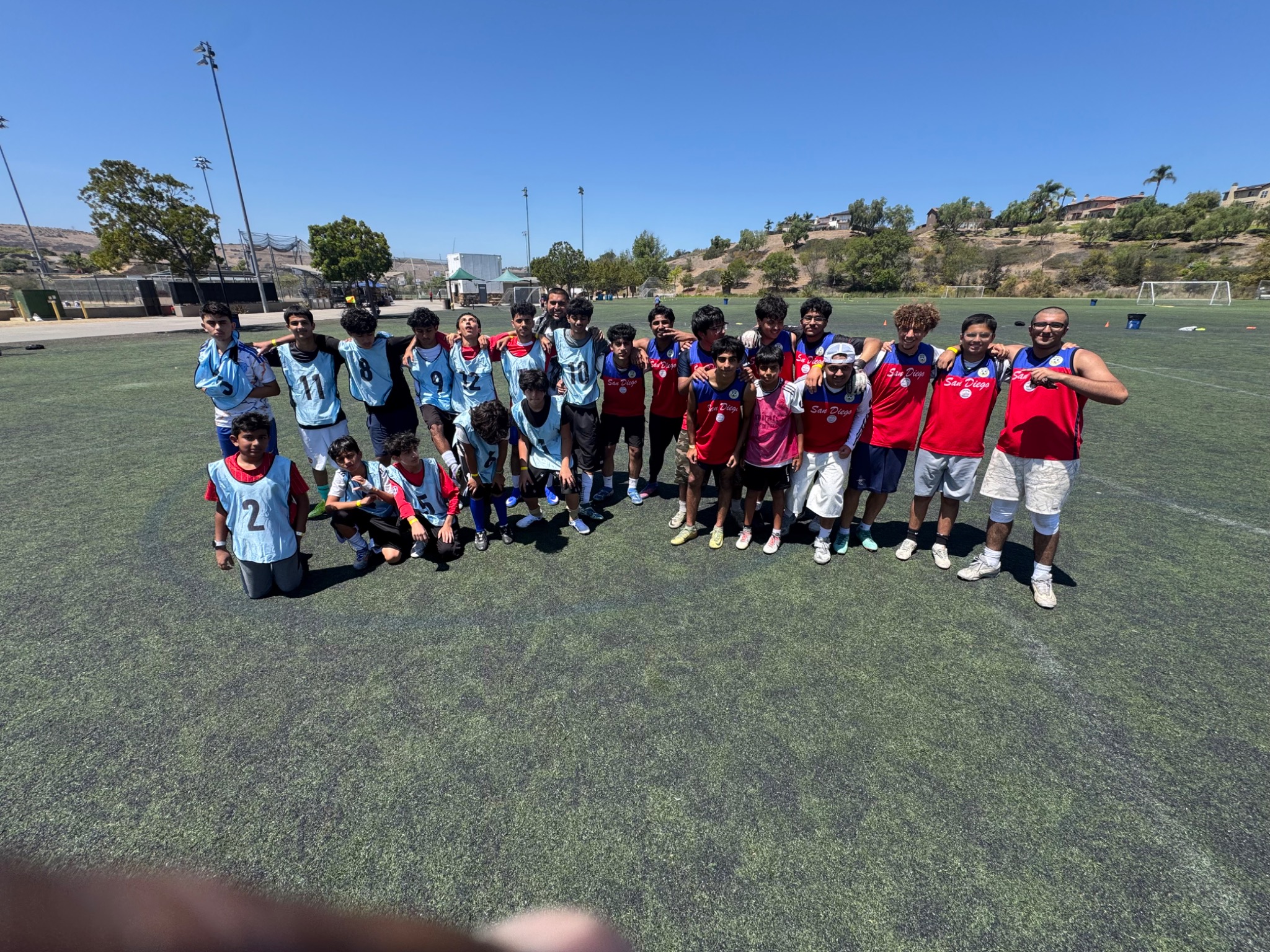 Two youth soccer teams sharing a candid post-match moment