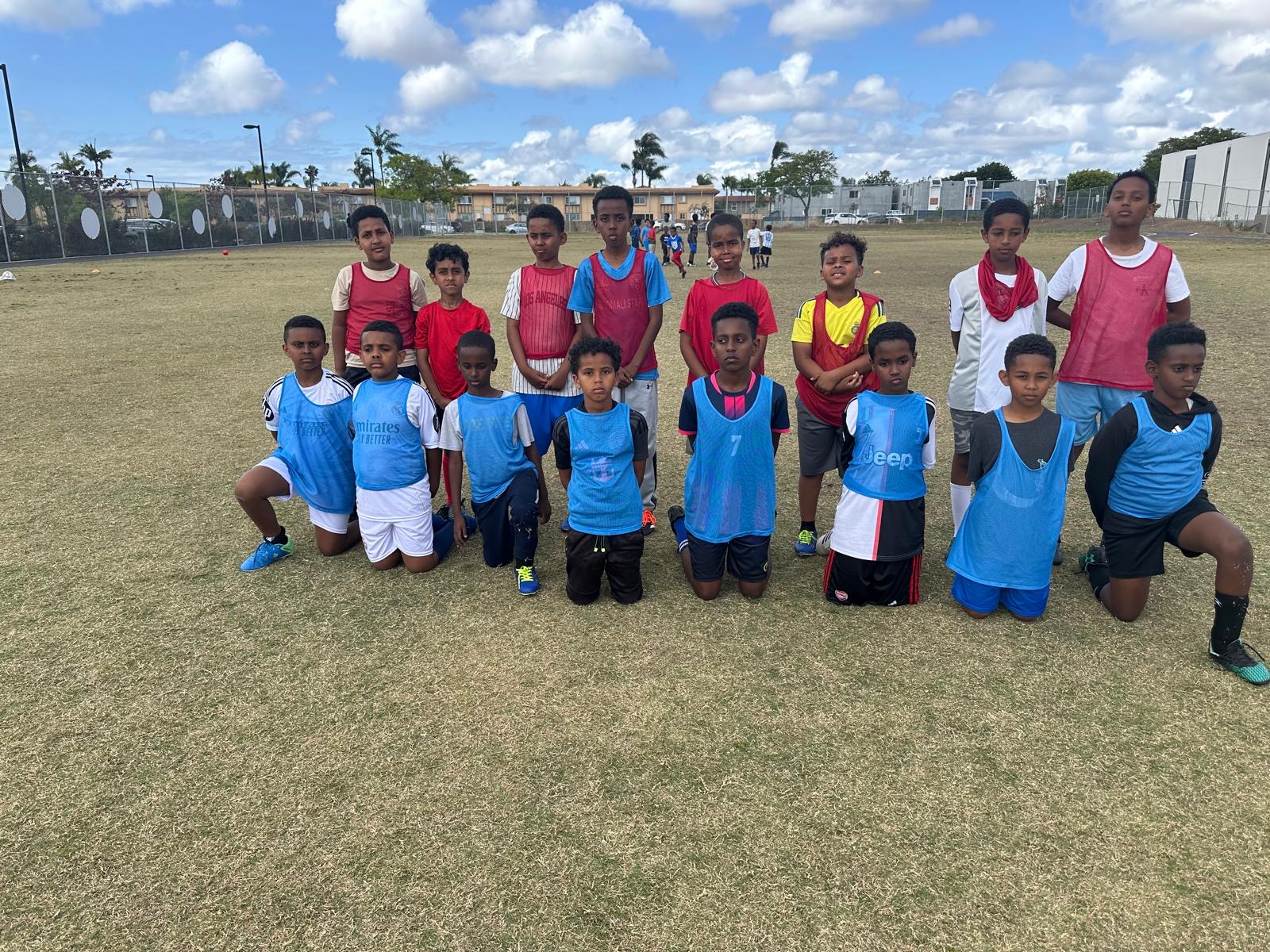 Youth soccer teams in red and blue training bibs